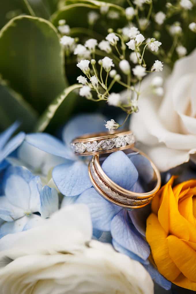 Wedding rings on blue flower background