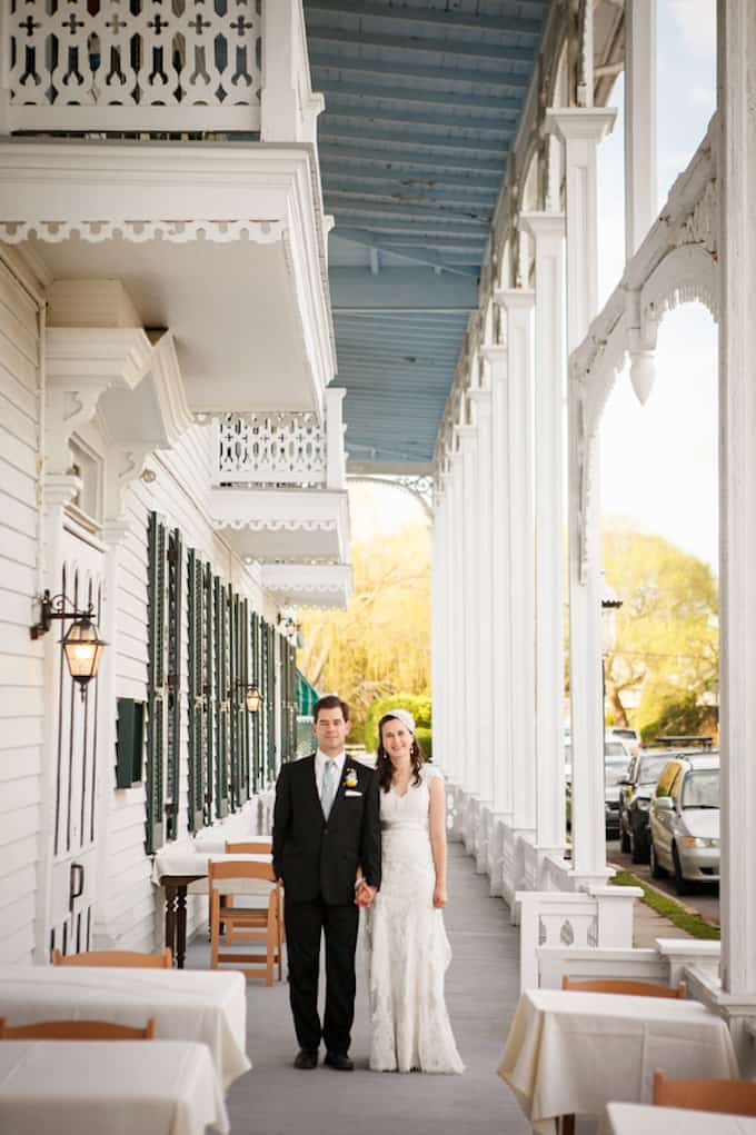 bride and groom standing on a wooden porch