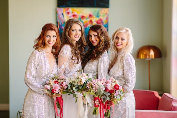 4 women with beautiful floral bouquets
