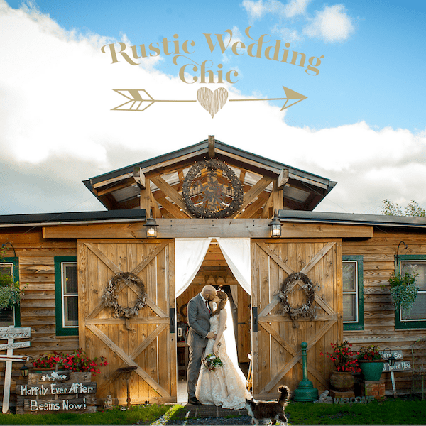 Farm Wedding bride and groom standing in open doors of barn kissing