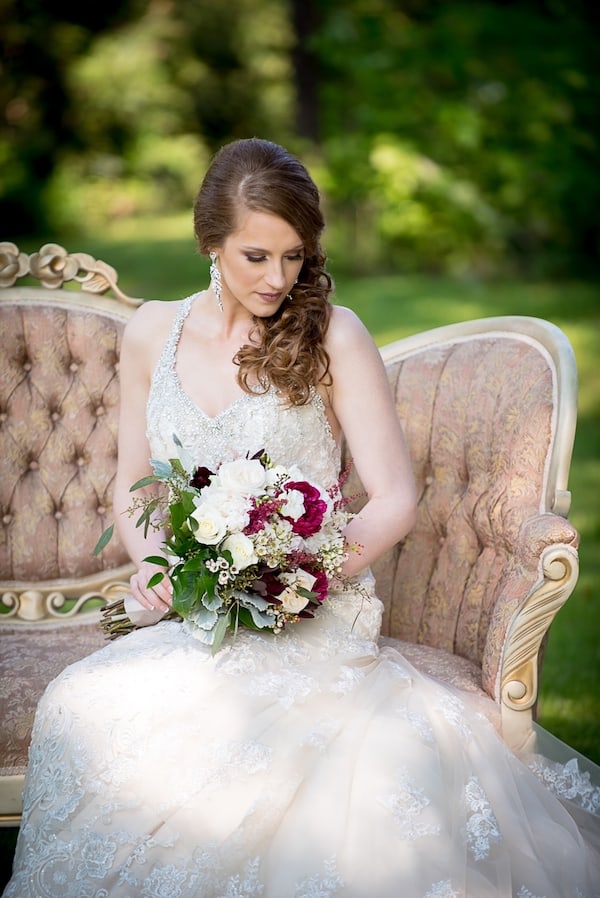 Bride holding bouquet on outdoor couch