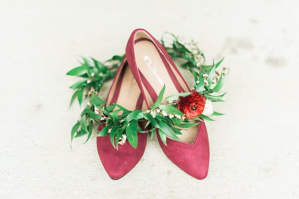 springtime blooms by the box red shoes with green floral crown laying on top of them