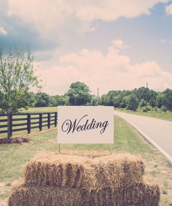 rustic country wedding sign on hay bales