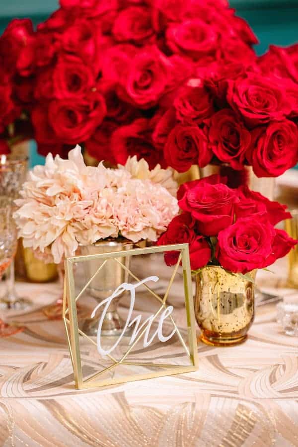 Hollywood Wedding, Glamorous, Bloomsbythebox table number One on glass and gold with red and peach flowers