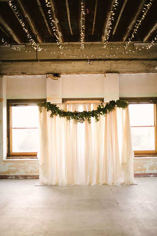 Simplify your floral arch by using inexpensive greens and sheer fabric!