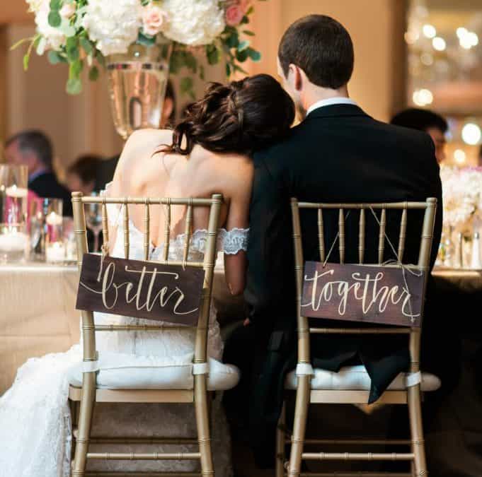 bride and groom in chairs labeled together forever