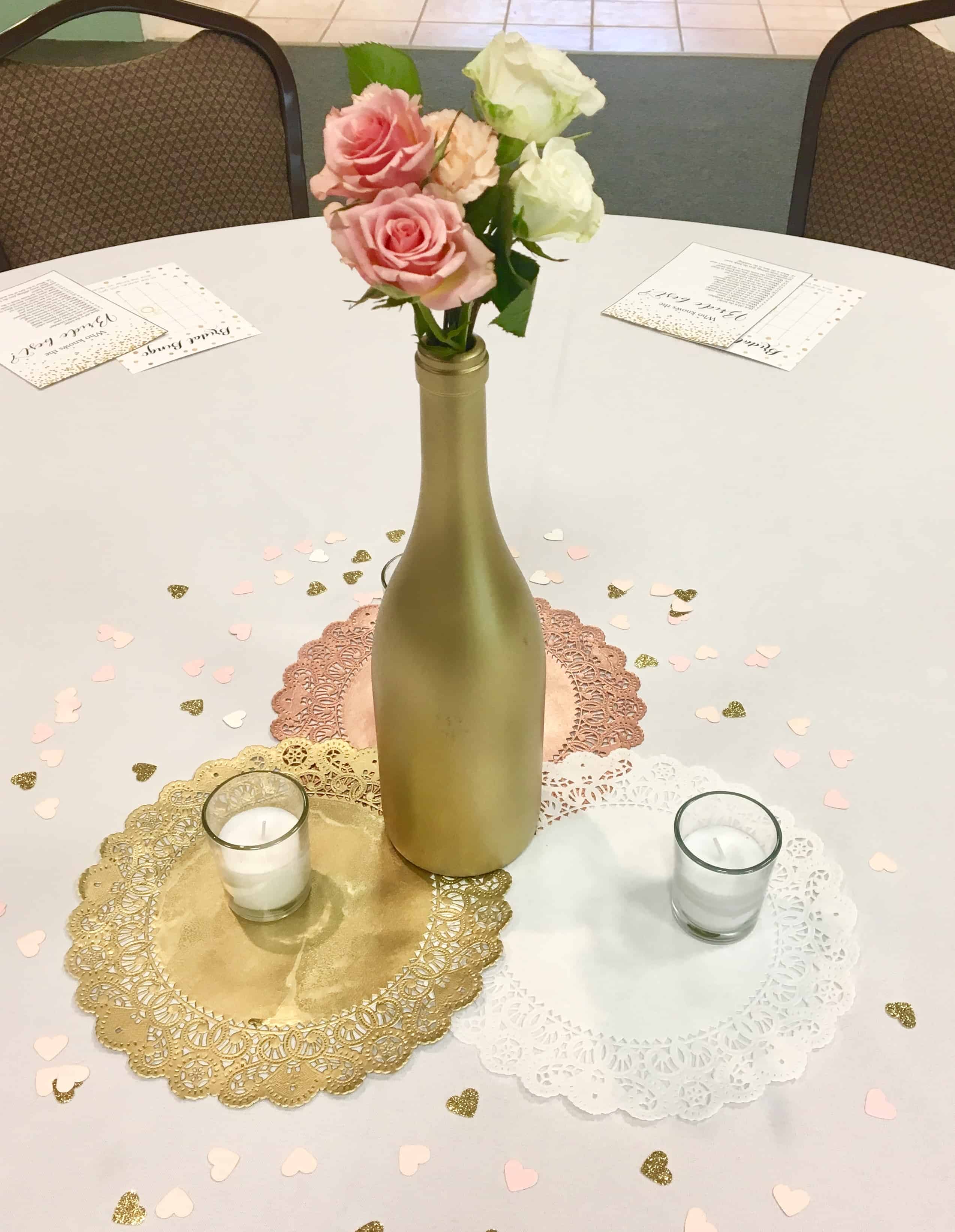 Table setting with pink and white flowers in a gold jar