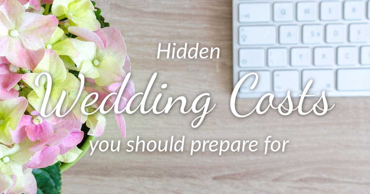 keyboard and green and pink flowers with words hidden wedding costs you should prepare for
