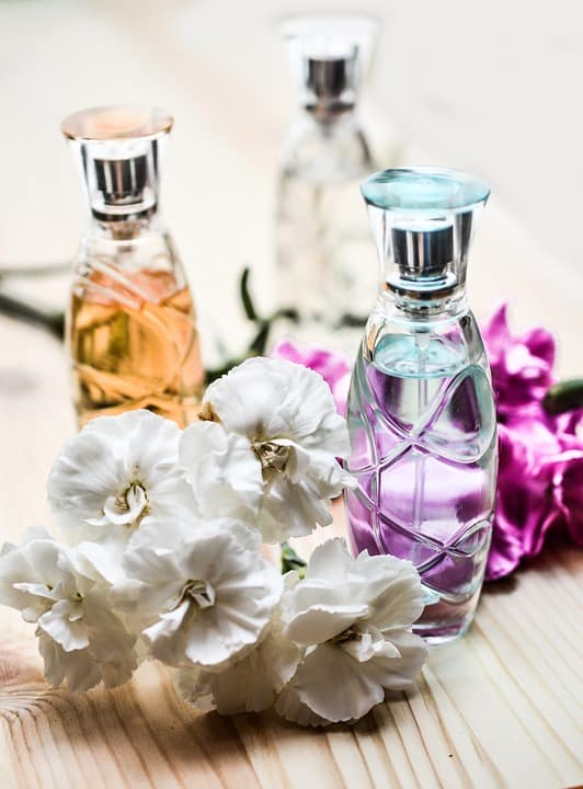 perfume bottles with white flowers