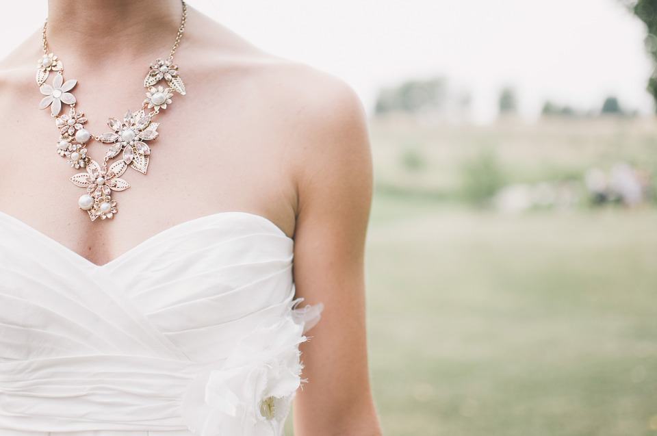wedding dress and white necklace on a bride