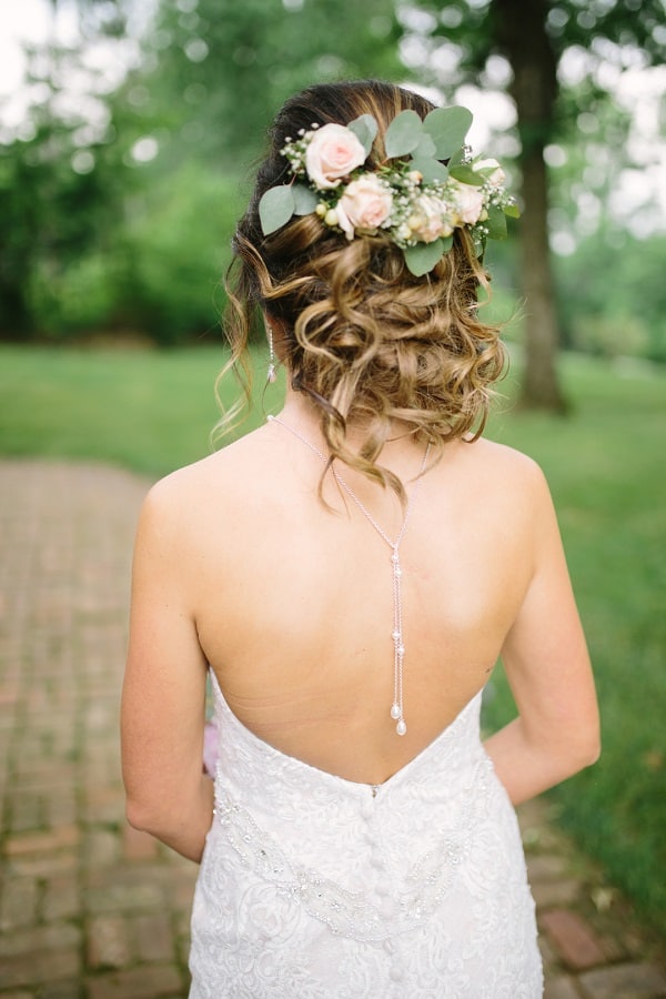 wedding cake with green leaf arrangement surrounding the outside