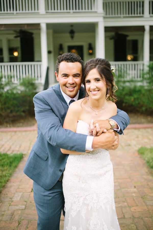 Back of bride's dress with hair having pink flowers with greens
