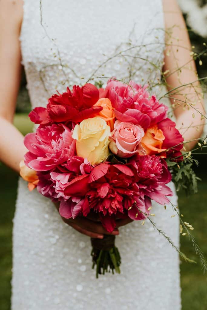 close up of orange pink and yellow bridal bouquet