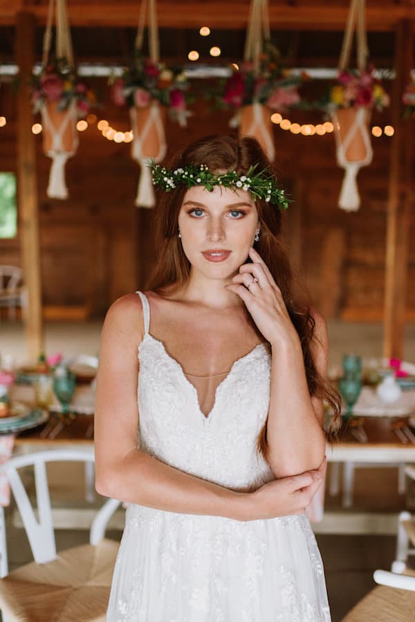 Bride with green floral crown with hanging flowers in the background