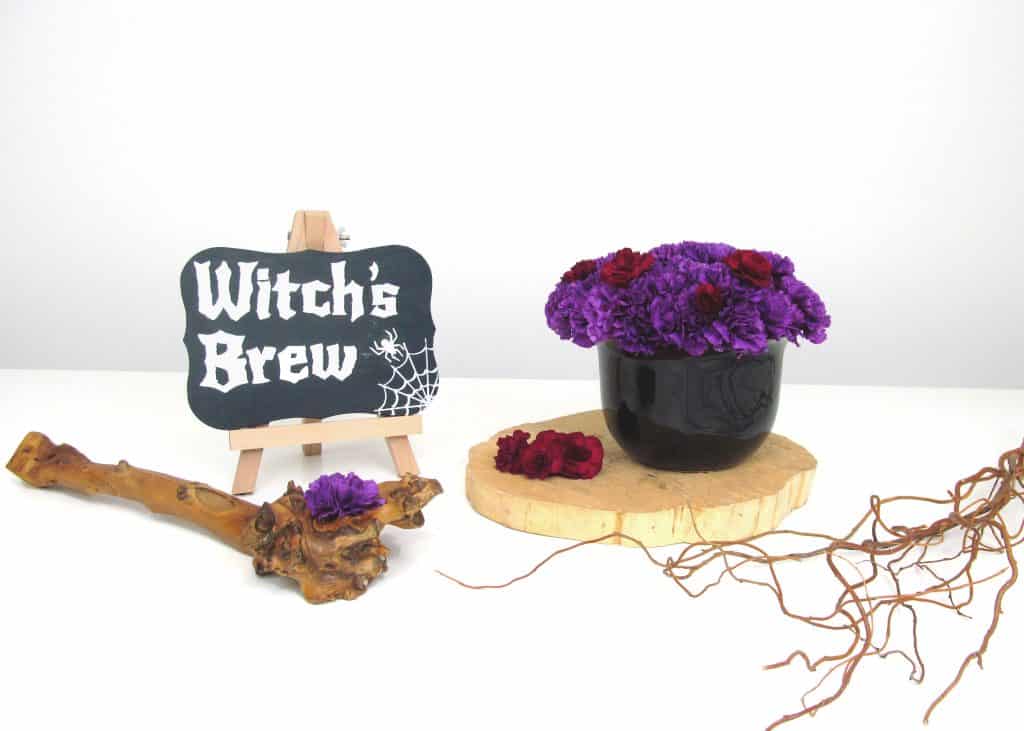 finished arrangement with purple carnations