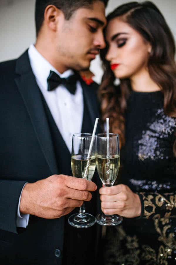man and woman pressing champagne glasses together