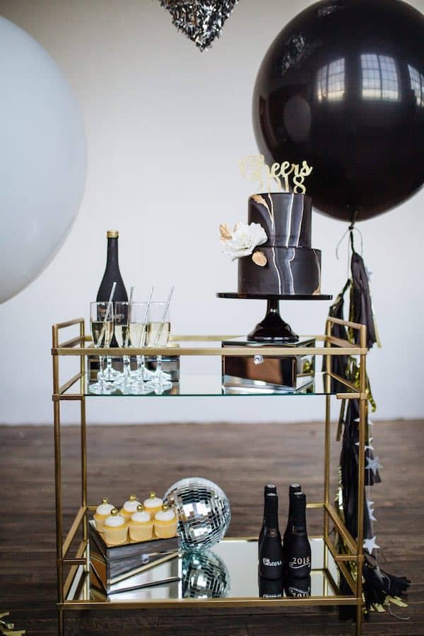 gold trimmed bar cart with various decoration