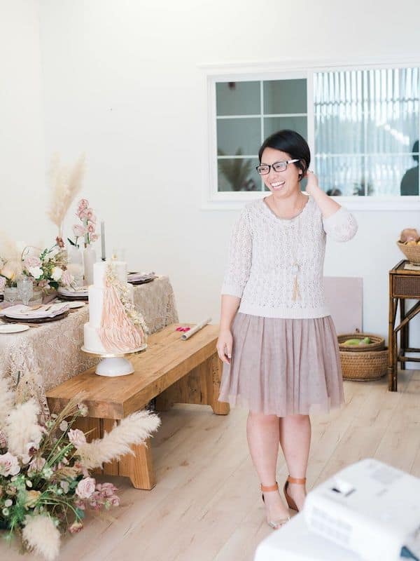 smiling woman with a decorated table in the background