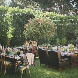 backyard wedding scene with tables chairs and decorations