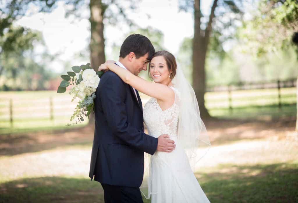bride and groom embracing outdoors