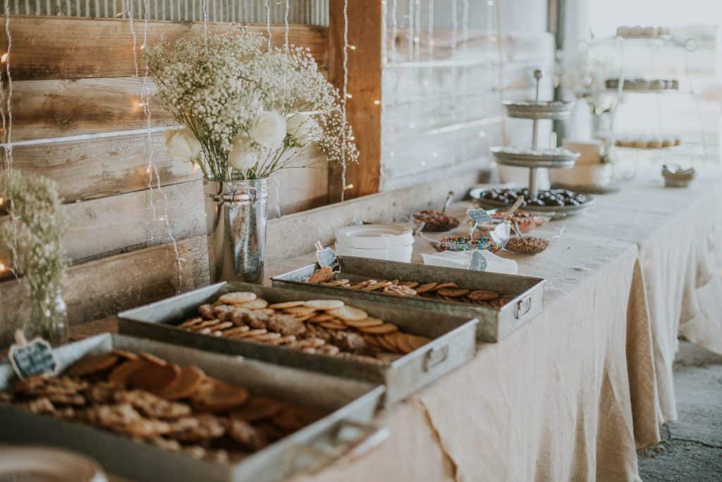 dessert table decorated with white flowers and babys breath