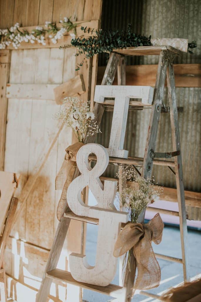cutouts of the letters t and j on a ladder