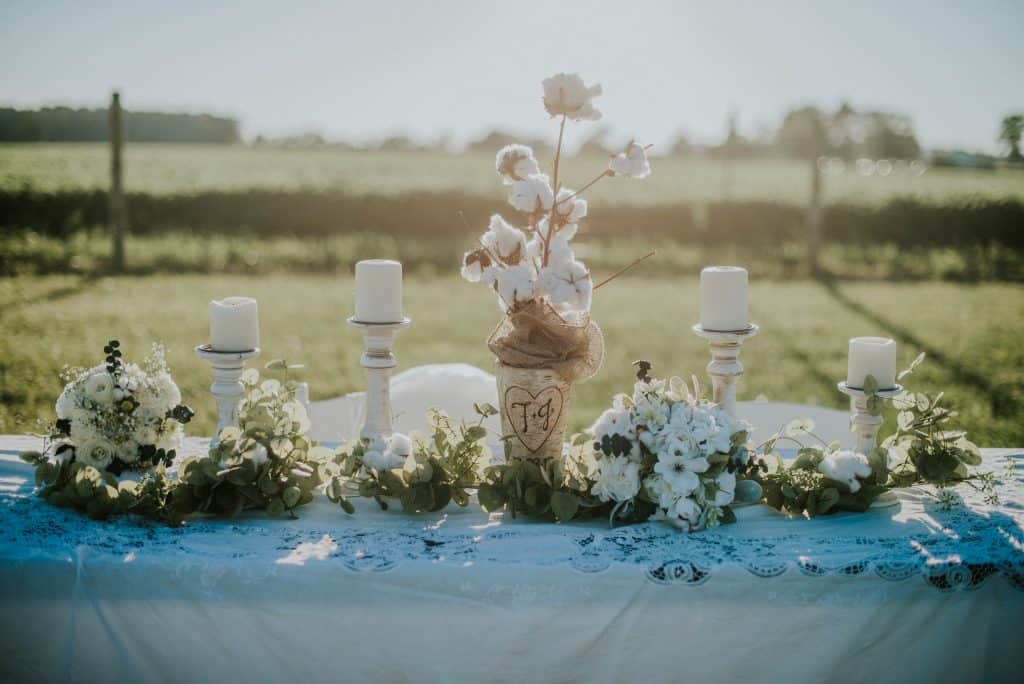 table with candles and white flowers