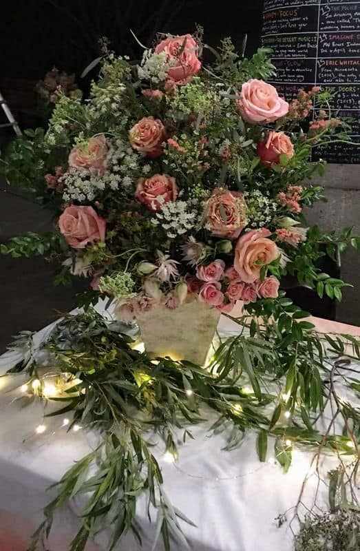 Pink floral arrangement in gold square vase 