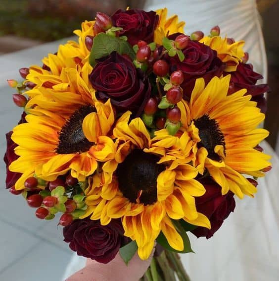 DIY Wedding Arrangement Sunflower burst bouquet with yellow sunflowers, red roses and red hypericum
