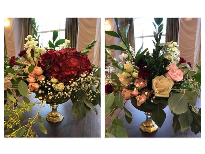 Red, pink and peach flowers on a gold pedestal