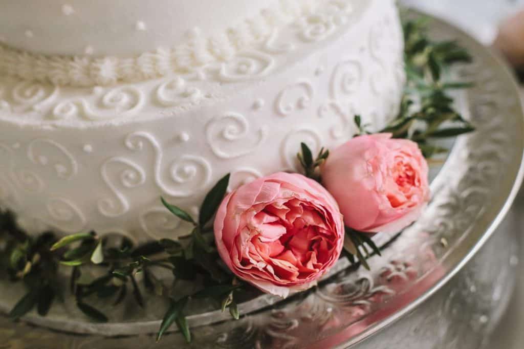 wedding cake decorated with real fresh pink flowers