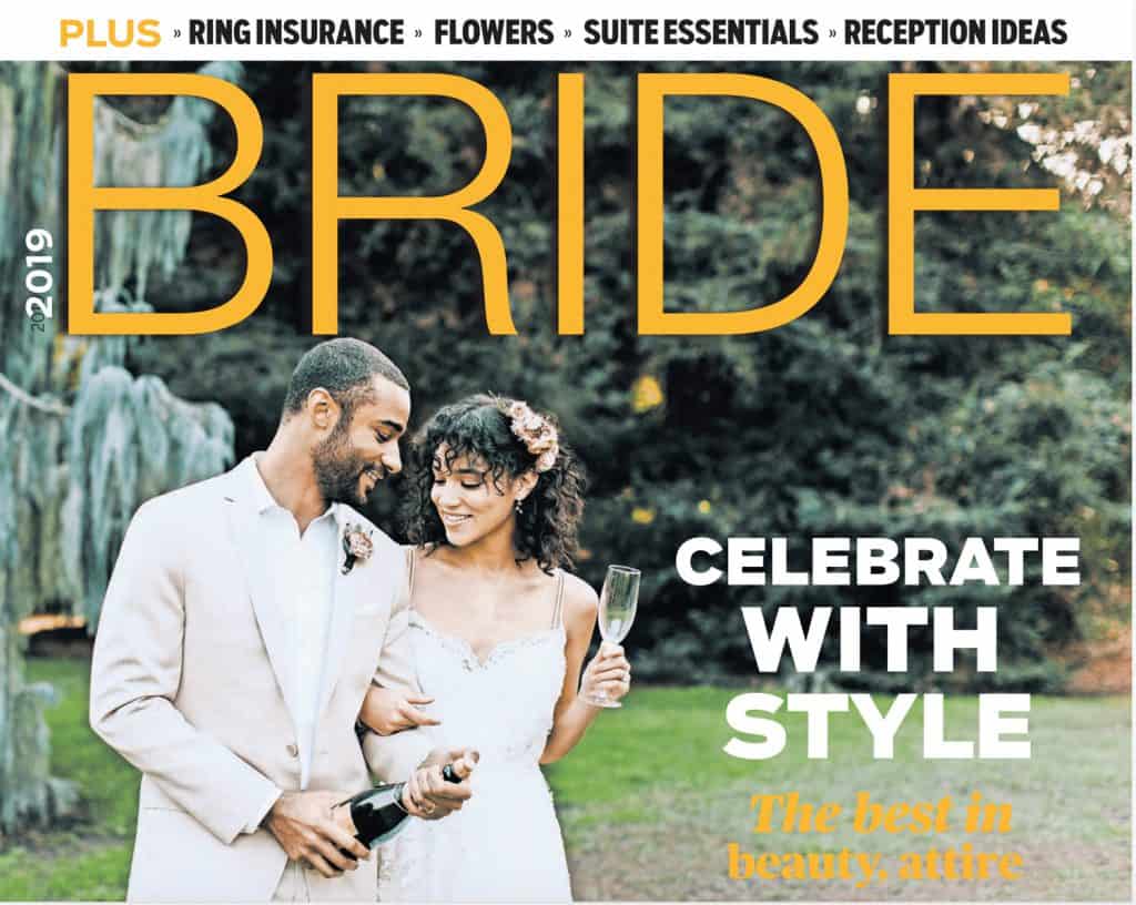 bride and groom about to open a bottle of champagne
