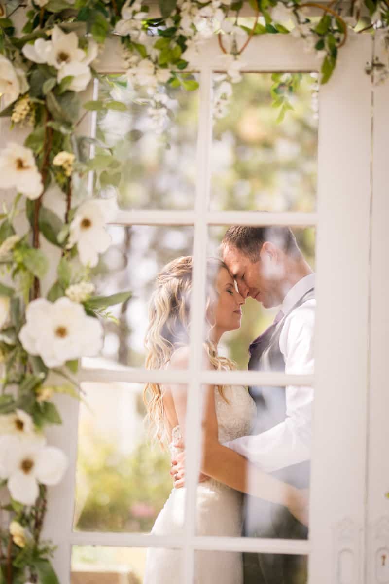 Wedding couple viewed through glass