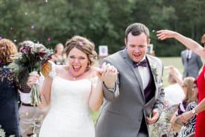 Bride and Groom with guests throwing confetti