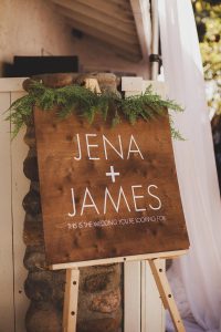 Jena + James sign with green ferns as trim