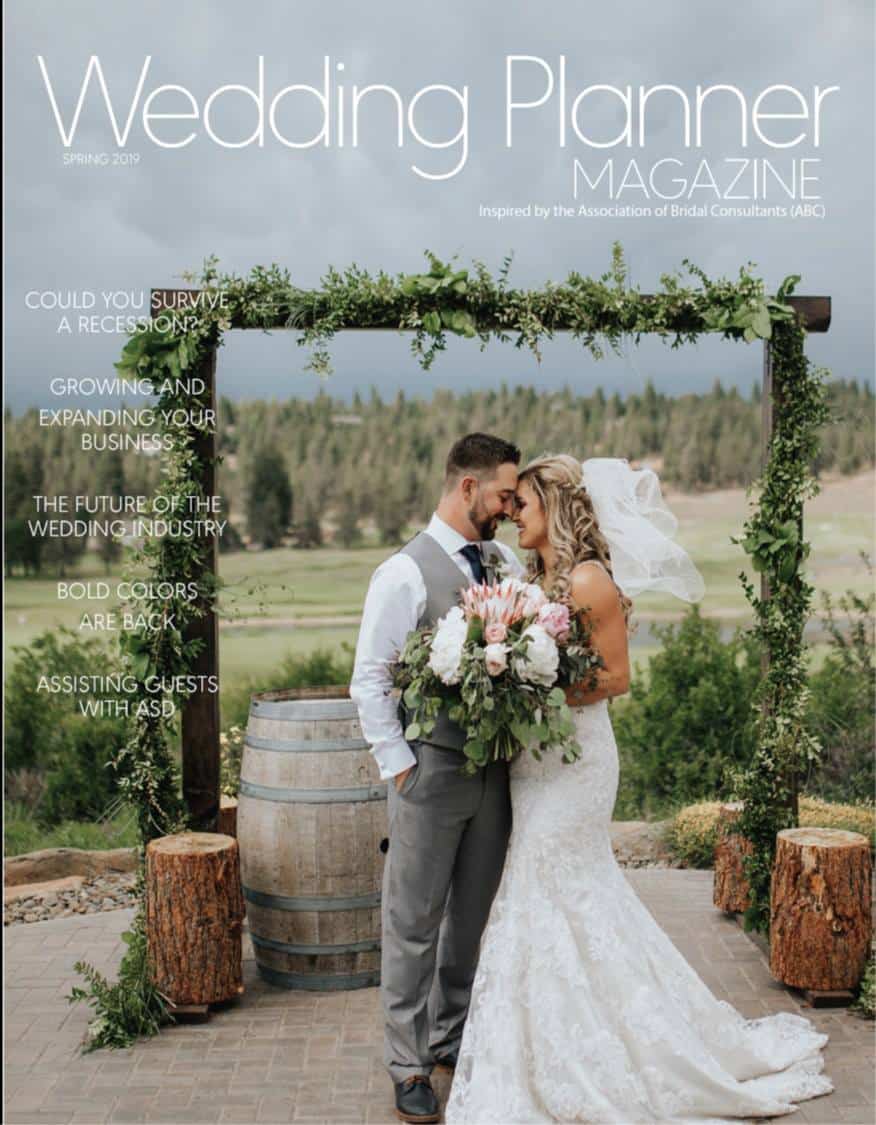 Bride and groom outdoor wedding with garland covered arch