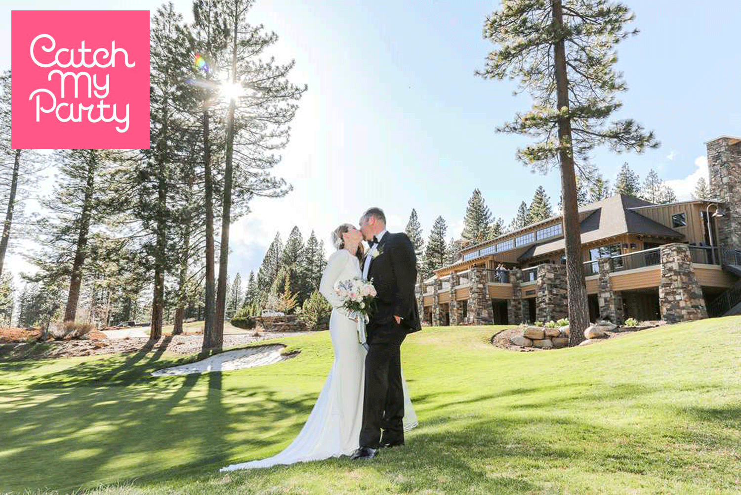 Bride and Groom kissing outdoor scene with golf course large trees and clubhouse background