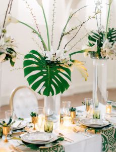 tall centerpiece with large tropical leaf