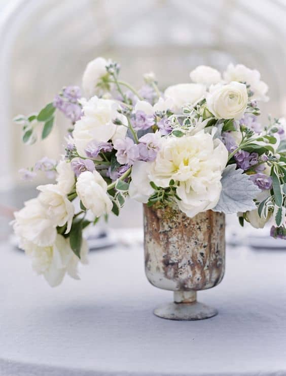white and light purple flowers in a silver vases