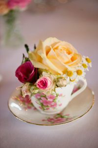 yellow and red flowers in a teacup