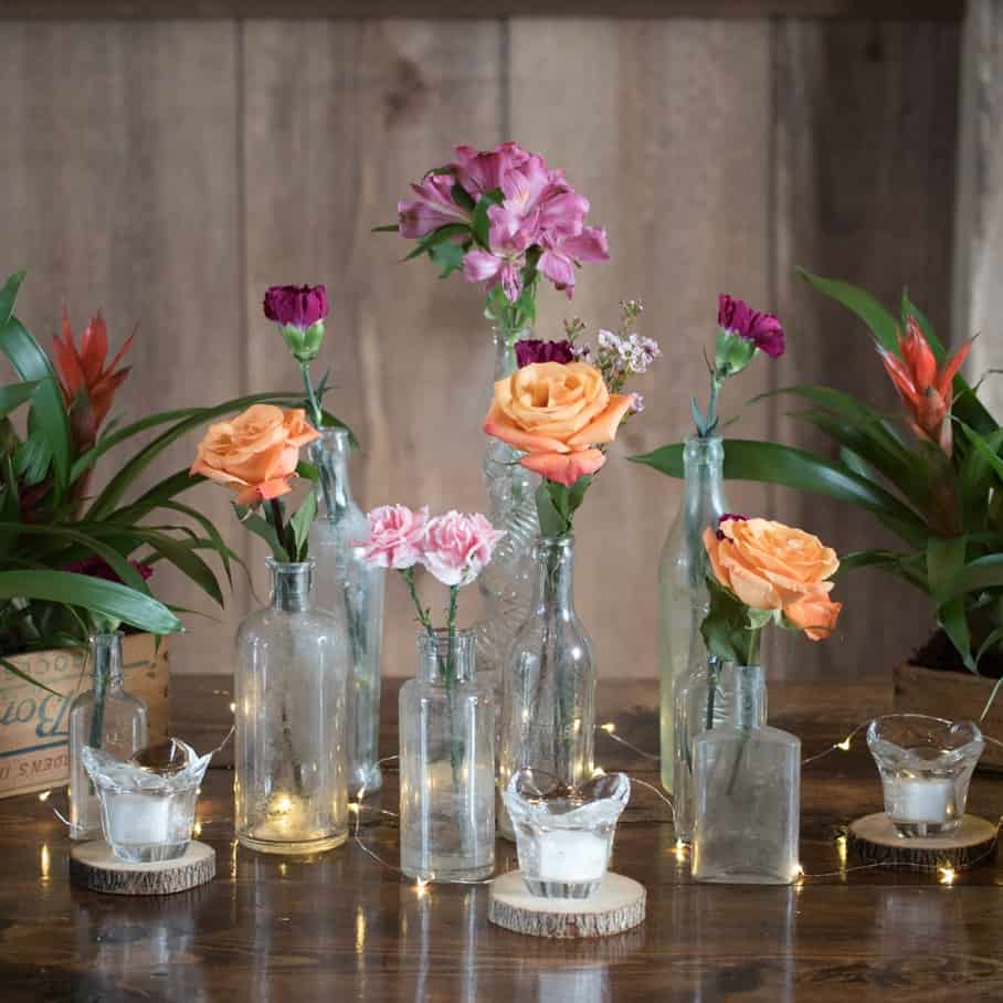 longstem orange and pink flowers in tall glass vases 