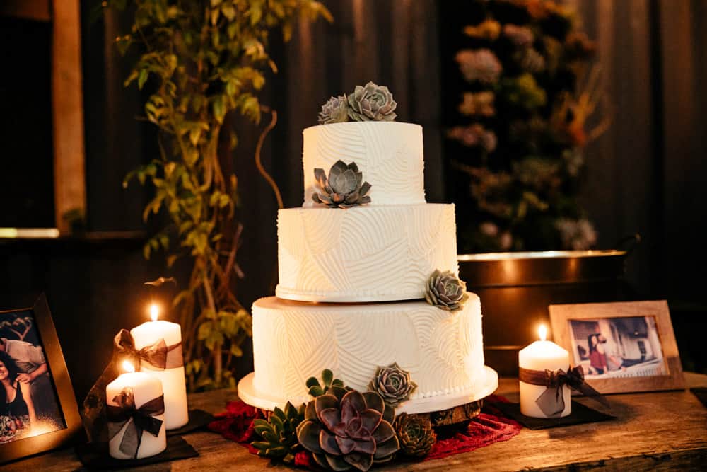 wedding cake decorated with green succulents