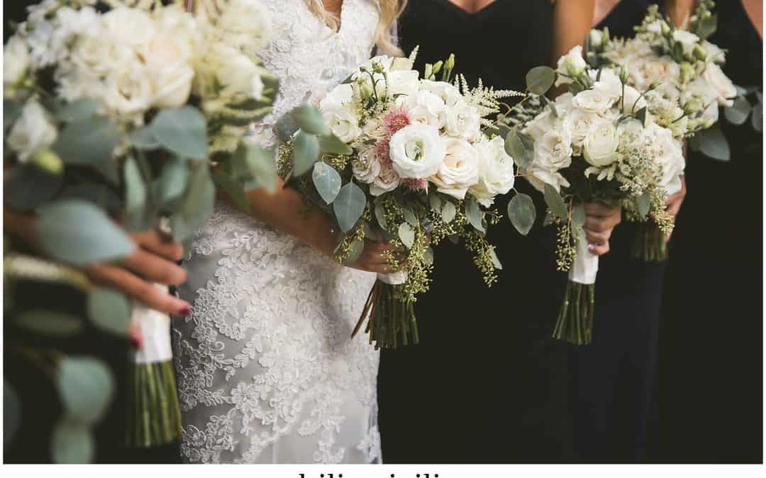 bride and bridesmaids with white floral bouquets