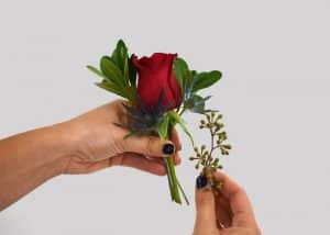 adding seeded eucalyptus to rose, pittosporum, and thistle