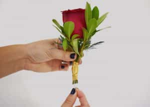 Pinning the boutonniere in place