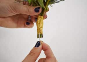 Pinning the boutonniere in place