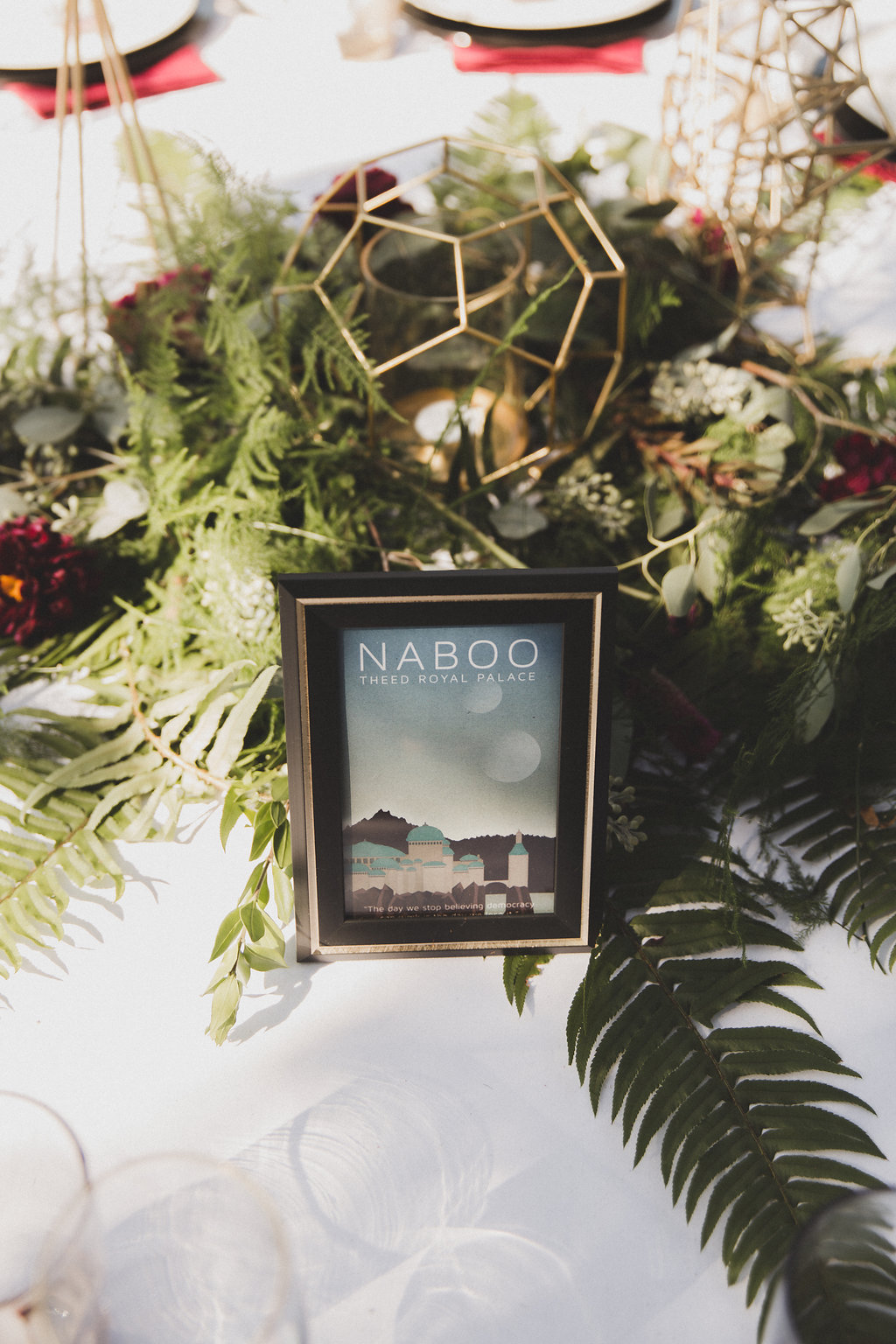 Greenery on table surrounding frame with castle