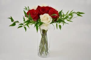 Adding your greenery around the edges of the vase