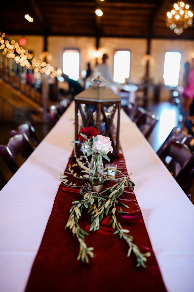 Table runner with green stems and purple and pink flowers
