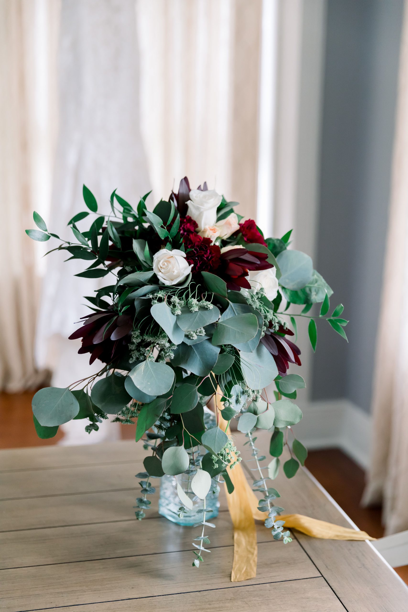 Red and white flowers in a glass jar
